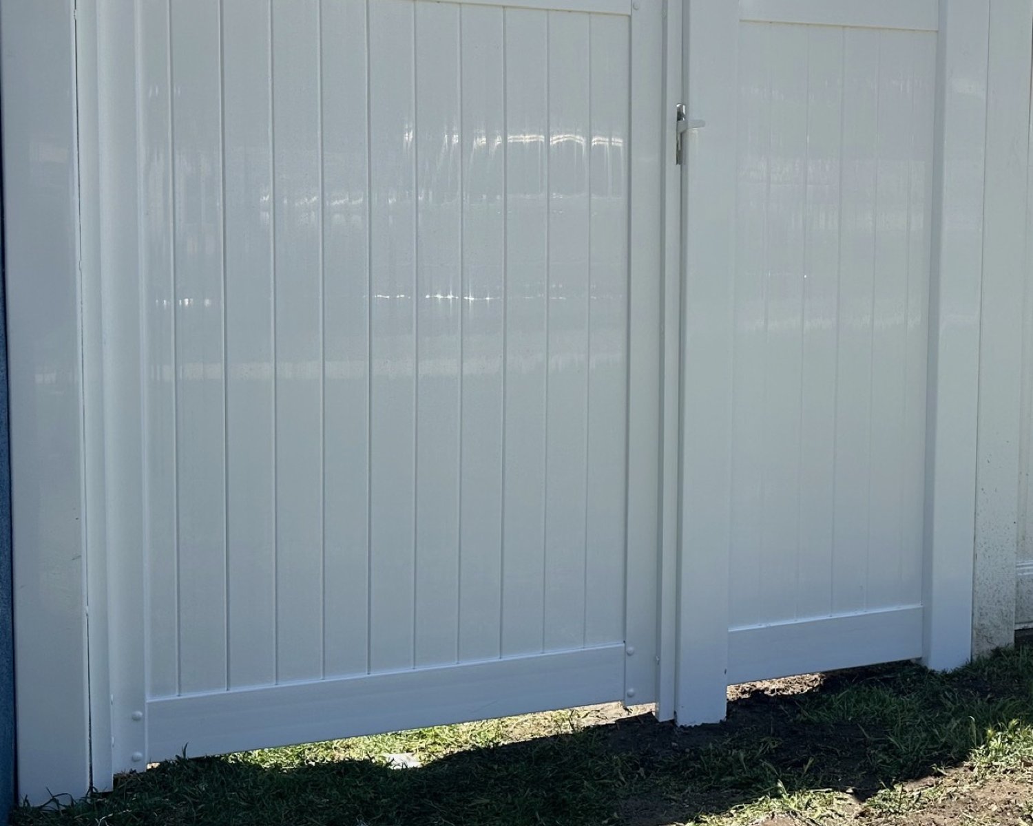 White vinyl privacy fence with pedestrian gate